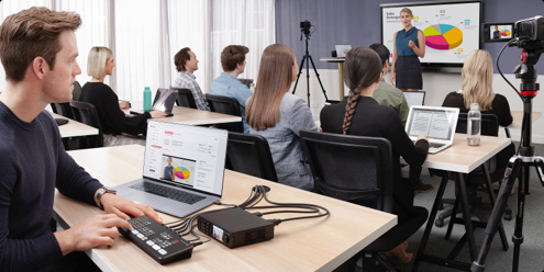 Person live streaming footage from a classroom