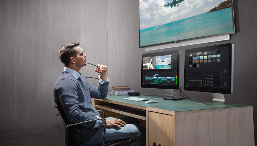 Man reviewing footage on DaVinci Resolve hardware and software